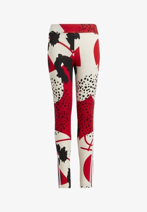 Leggings en tissu extensible, arborant un motif abstrait rouge, noir et beige avec des formes géométriques et des accents de taches.
