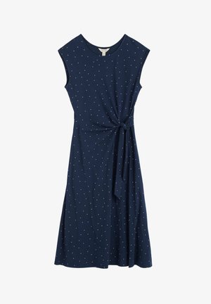 Tummansininen mekko, jossa on hihattomat hihat, polvenpituinen, solmu yksityiskohtana vyötäröllä ja valkoisia pilkkuja koko mekossa. Pehmeä kangas.