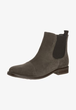Bottine Chelsea en daim marron avec panneau latéral élastique, bout arrondi, petit talon empilé et languette à l’arrière.