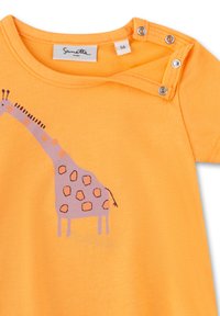 Orange cotton t-shirt featuring a giraffe illustration in purple and peach, with snap closures on the left shoulder for easy dressing.