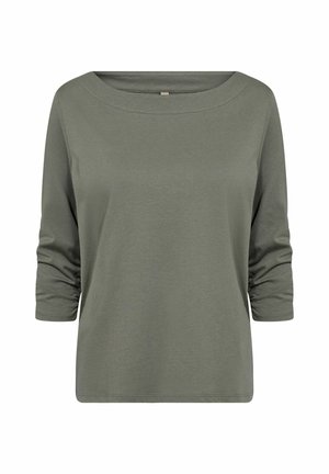 Olívazöld, hosszú ujjú felső széles hajónyakkivágással és redőzött ujjakkal. Puha, sima pamut anyagból készült.