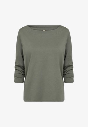 Olívazöld, hosszú ujjú felső széles hajónyakkivágással és redőzött ujjakkal. Puha, sima pamut anyagból készült.