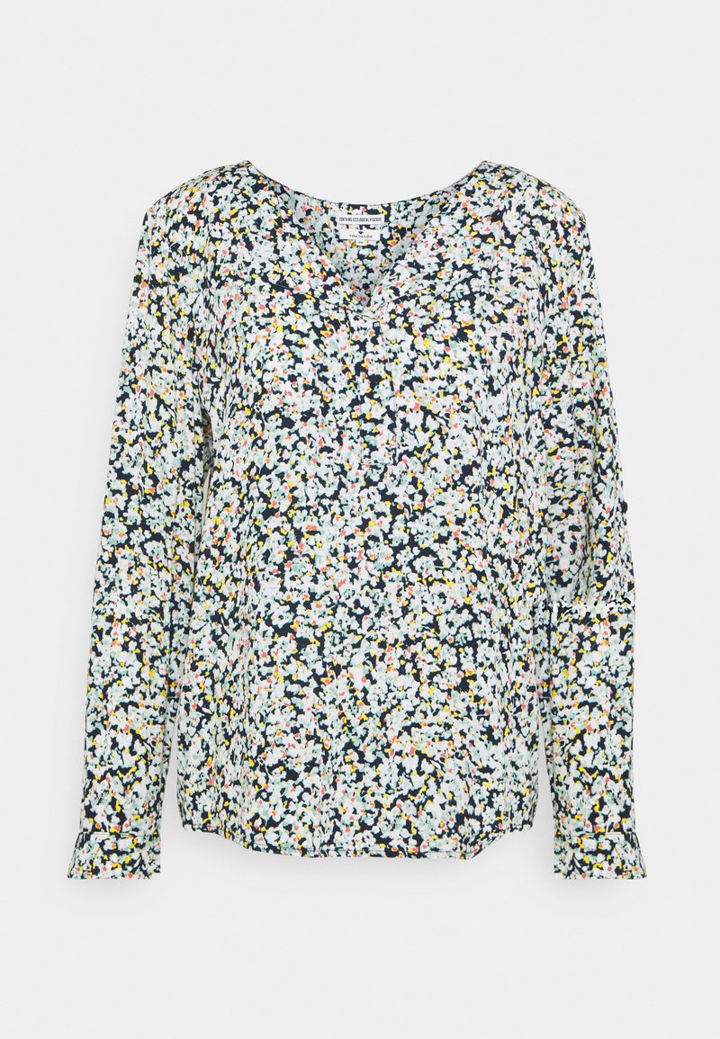 Blouse à manches longues avec un motif floral sur fond bleu marine, ornée de fleurs blanches, roses et jaunes. Encolure arrondie, épaules légèrement froncées.