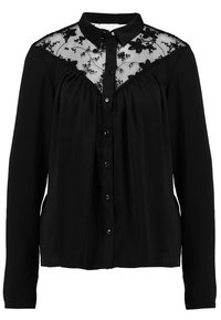 Blouse noire à manches longues avec devant boutonné, empiècement en dentelle florale transparente et tissu froncé sous le panneau en dentelle.