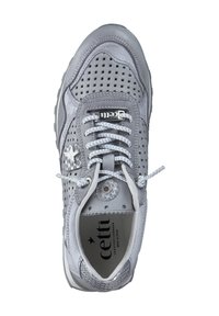 Gray athletic shoe with perforated leather design, flat white laces, metallic accents, and a cushioned sole. Brand logo visible inside.