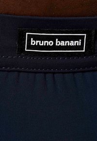 Navy fabric swimwear featuring an elastic waistband and a label with "bruno banani" in white lettering on a black background.