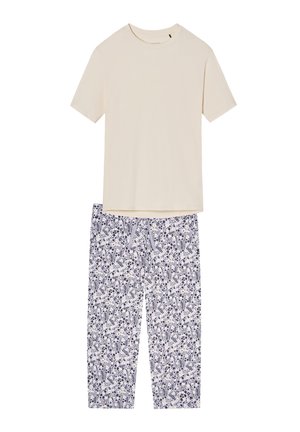 Lyhythihainen kerma-beige paita yhdistetty valkoisiin pyjamahousuihin, joissa on sininen ja keltainen kukkakuvio ja nyörivyötärö.