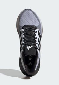 Black and gray athletic shoe featuring a mesh upper, black laces, three white stripes on the sides, and a padded black tongue.
