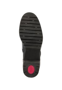 Semelle de chaussure noire présentant une surface en caoutchouc texturé avec des rainures horizontales et un accent rouge circulaire au niveau du talon étiqueté "confort".