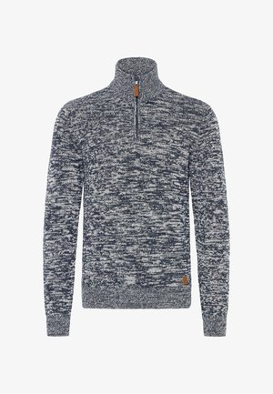 Adata zeķīte zilā un baltā krāsā ar ceturtdaļas rāvējslēdzēju, kas piedāvā teksturētu rakstu un mazu brūnu ādas logotipa uzlīmi uz apakšmalas.