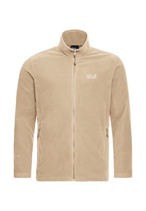 Veste en polaire beige avec un col montant, une fermeture éclair intégrale et deux poches latérales. Présente un logo sur la poitrine gauche. Texture lisse.