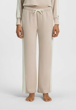 Beige sweatpants met crèmekleurige zijstrepen, voorzien van een elastische tailleband en een trekkoord. Gemaakt van zachte stof, met een ontspannen pasvorm.