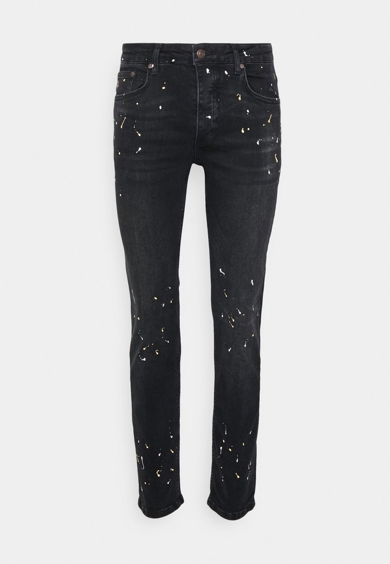 Černé džíny z denimu se slim fit střihem, s barevnými skvrnami v bílé a zlaté barvě. Pětipocket design s knoflíkovým a zipovým zapínáním.