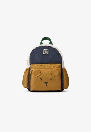Mochila infantil en azul marino y beige con diseño de cara de oso, asa verde, ribete blanco y bolsillo frontal con cremallera y orejas. Tejido duradero.