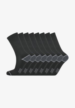 Chaussettes noires à côtes disposées en rang, avec un talon et un orteil renforcés. Chaque chaussette présente un motif de rayure blanche près du haut. Paquet de dix.