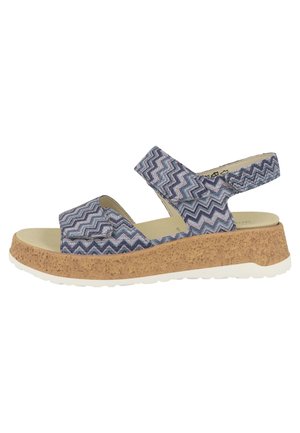 Dámská sandála s modrými pásky se vzorem cikcak, nastavitelnými suchými zipy a korkovou platformou s bílou gumovou podrážkou.