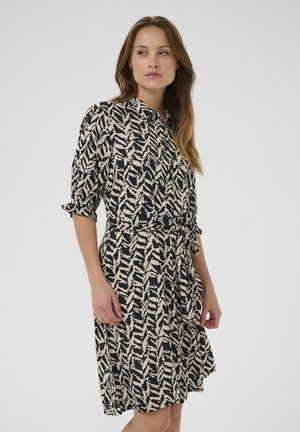 Kurzärmliges Kleid mit einem schwarz-beigen abstrakten Muster, Kragen, und einem gebundenen Taillenelement. Leichter Stoff.