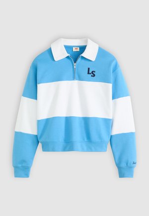 Blå og hvitstripet genser med glidelås i kragen, med bokstavene "LS" brodert i mørk blå på brystet. Mykt materiale, kort design.