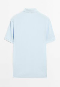 Light blue polo shirt with short sleeves, collar, and a smooth texture. The back view shows a simple, classic design without patterns.