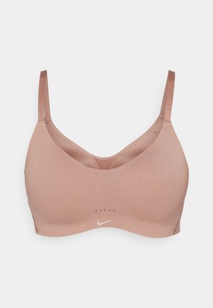 Nike sports-bh i lys brun med en glatt tekstur, v-hals design, justerbare stropper og liten logo nær bunnen.