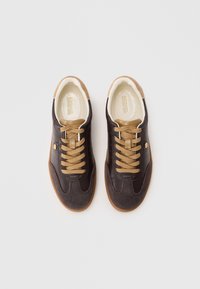 Pair of brown and tan leather sneakers with suede toes, lace-up design, and branded insoles, shown from top view on white background.