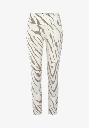 Leggings van zachte stof, met een witte basis en gedurfde, golvende bruine zebraprints, hoge tailleband en een gladde textuur.