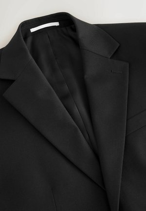 Black tailored suit jacket with notch lapels, visible stitching on buttonhole, and smooth fabric texture on a light background.
