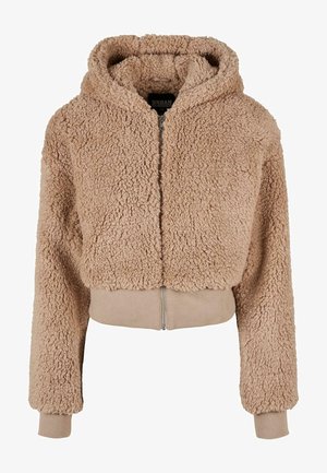 Veste courte couleur fauve avec une texture duveteuse, fermeture éclair sur le devant et capuche. Poignets et ceinture côtelés ; tissu doux et pelucheux pour plus de chaleur.