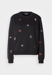 Sweat-shirt noir à manches longues avec petits symboles brodés rose et marron, incluant feuilles, étoiles, cœurs et formes abstraites, vue de face.