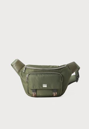 Olive green fanny pack made of nylon, featuring a zippered main compartment, front pocket with decorative hardware, and adjustable strap.