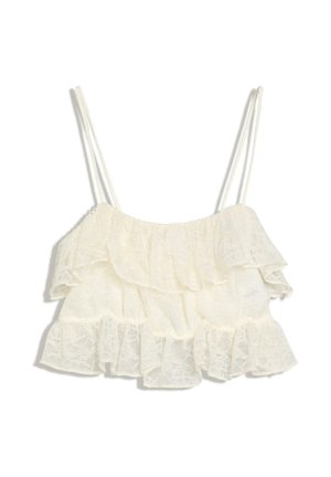 Top corto in pizzo bianco con doppie spalline sottili e volant a strati lungo lo scollo e l'orlo.