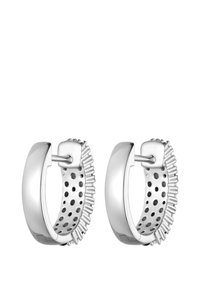 Silver hoop earrings featuring a smooth exterior with textured ridges and dotted accents on the inside for added detail and contrast.