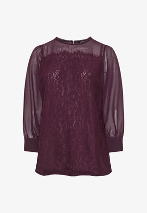 Burgundowa bluzka z przezroczystymi długimi rękawami i koronkowym wykończeniem. Okrągły dekolt i ściągacze przy mankietach. Zapięcie z tyłu z małym otworem w kształcie klucza.