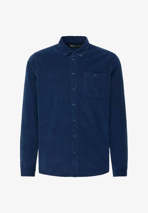 Mornarsko plava kord majica s dugim rukavima, dugmadi i ovratnikom, s jednim džepom na prsima. Mekana tekstura i regularna kroja.