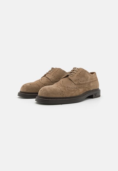 Suede brown brogue shoes with round toe, detailed perforations, lace-up design, and contrasting dark sole with stitching accents.