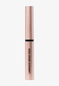 Tubo cilindrico in oro rosa con finitura opaca, fascia nera e testo in grassetto che recita "LAMINATE BROW FIXER" in un font sans-serif.