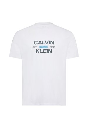 Bílé tričko s krátkým rukávem s nápisem „Calvin Klein EST 1968“ ve velkém šedém a černém textu na přední straně.