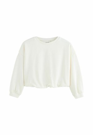 Sweatshirt cropped blanc avec des manches longues légèrement bouffantes. Fabriqué en tissu doux, il présente un col rond et des poignets côtelés.