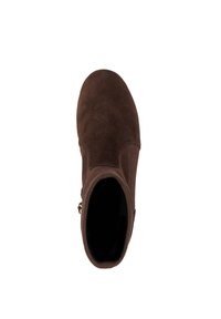 Brown suede ankle boot with rounded toe and side buckle viewed from above on white background.
