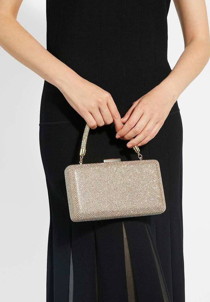 Clutch bag made of metallic fabric with a textured, sparkling surface. Features a short, beaded handle and a rectangular shape.