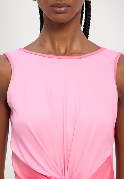 Pink sleeveless top with a smooth, stretchy fabric. Features a knotted detail at the waist, creating a draped effect.