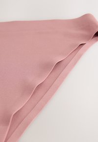 Soft pink fabric with a smooth texture, featuring gentle folds along the edge and a clean, sleek design. Lightweight and flexible material.
