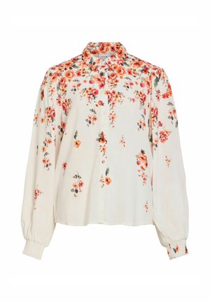 Pitkähihaisen kermaan sävyinen pusero, jossa oranssi-punainen kukkakuvio, napillinen edusta, suippo kaulus ja kerätyt kalvosimet.