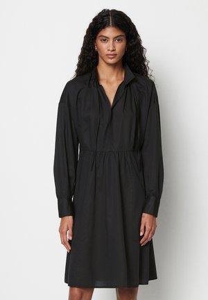 Vestito camicia nero con maniche lunghe, colletto e vita arricciata. Realizzato in tessuto liscio con una vestibilità comoda e una leggera lucentezza.