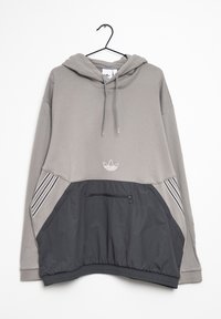 Grå hoodie med kenguruficka, dragskohuva och elastiskt midjeband. Har en kontrasterande panel i mörkgrått och tre vita ränder.