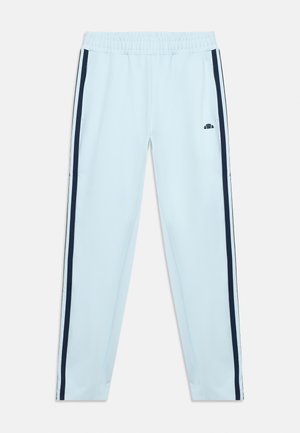 Hele sinised sportlikud püksid elastse vöökohaga, tumesiniste küljeribadega ja väikese musta logoga ülemisel reiel valgel taustal.