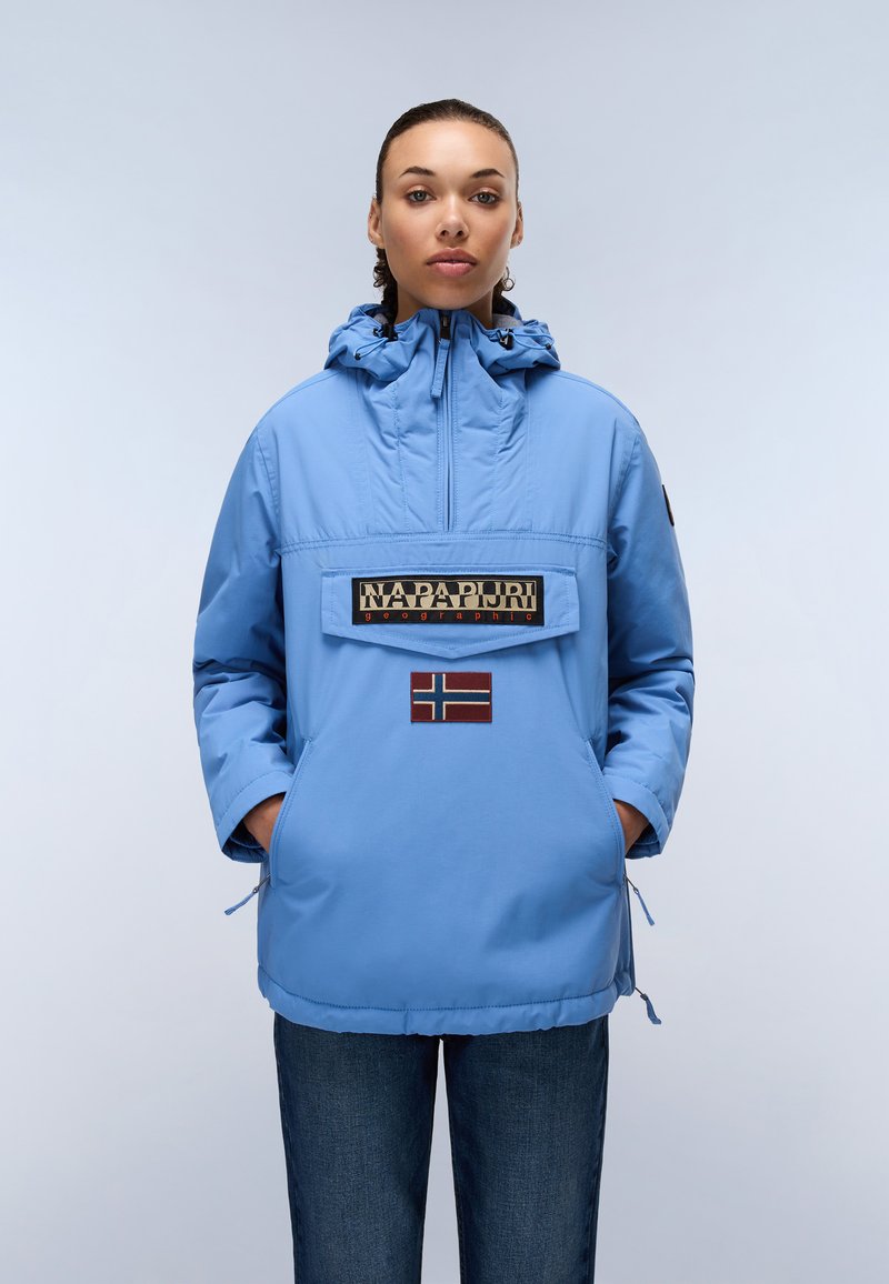 Light blue jacket with adjustable hood, front pocket, and Norwegian flag patch. Material appears smooth, with a relaxed fit and drawstring at hem.
