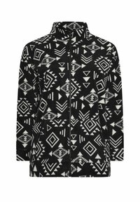 Giacca in pile bianco e nero con motivi geometrici, colletto alto, zip frontale e tasche laterali. Texture morbida e design dalla vestibilità rilassata.