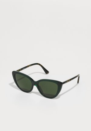 Green cat-eye sunglasses with dark green lenses. Thick plastic frame, featuring tortoiseshell accents on the temples. Sophisticated design.