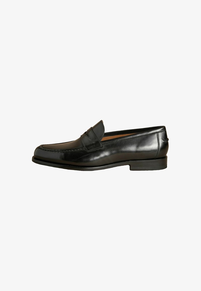Black leather loafer with a smooth finish, rounded toe, and decorative stitching. Features a low, flat heel and a slip-on design.